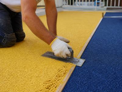 Crew installing rubber surfacing at a daycare