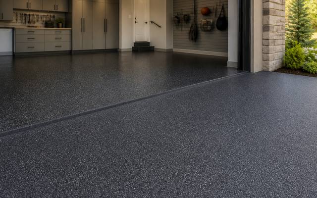 Finished rubber resurfaced garage floor with a car parked on it