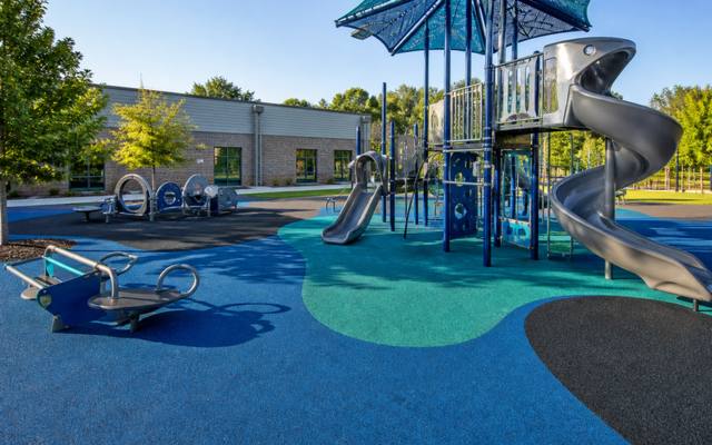 Finished poured rubber playground safety surfacing under play equipment